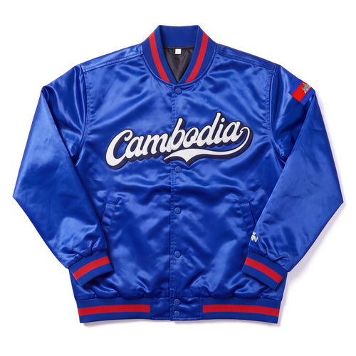 A royal blue Cambodia satin varsity bomber jacket with 'Cambodia' written in white script across the chest, featuring red and navy striped ribbed collar, cuffs, and hem, and a small red and blue patch on the right sleeve.