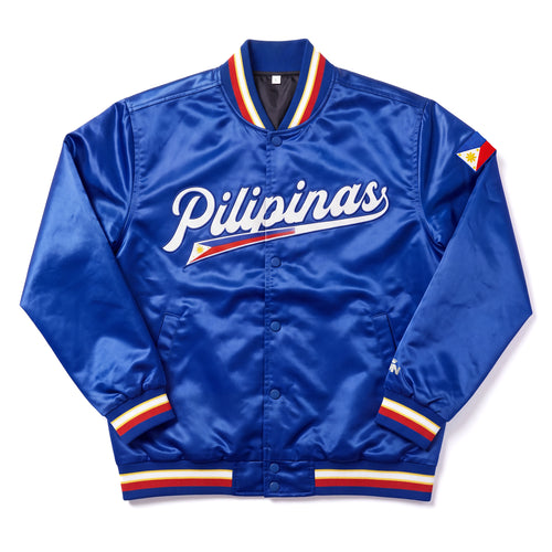 Philippines royal blue satin varsity bomber jacket featuring 'Pilipinas' in white script across the chest, with a small Philippine flag graphic underneath. The jacket has red, white, and blue striped ribbed collar, cuffs, and hem, and a small Philippine flag patch on the right sleeve.
